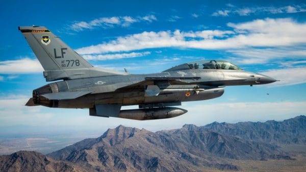 A U.S. Air Force F-16 Fighting Falcon assigned to the 56th Fighter Wing, Luke Air Force Base, Arizona, flies over Phoenix during the NASCAR Cup Series Championship Nov. 7, 2021. F-16 pilots assigned to the 56th and 944th FW, which train U.S. Air Force F-16 pilots, performed a 4-ship formation flyover at the conclusion of the U.S. National Anthem at the Phoenix Raceway to kick-off the championship race. Luke AFB continually bolsters partnerships with various organizations around Arizona, gaining support from the surrounding community.