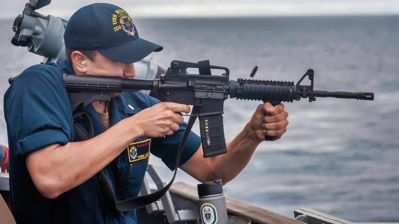 PACIFIC OCEAN - (Sept. 18, 2021) -- Lt. j.g. Dominic Galaz, from Las Cruces, N.M., fires an M4 carbine rifle off the port bridge wing aboard the Arleigh Burke-class guided-missile destroyer USS Mustin (DDG 89) during a live-fire exercise, Sept. 18, 2021. Mustin is currently underway in the U.S. 4th Fleet area of responsibility conducting a series of exercises designed to increase interoperability and build capacity among partner nations. (U.S. Navy Photo by Mass Communication Specialist 2nd Class James S. Hong/Released)