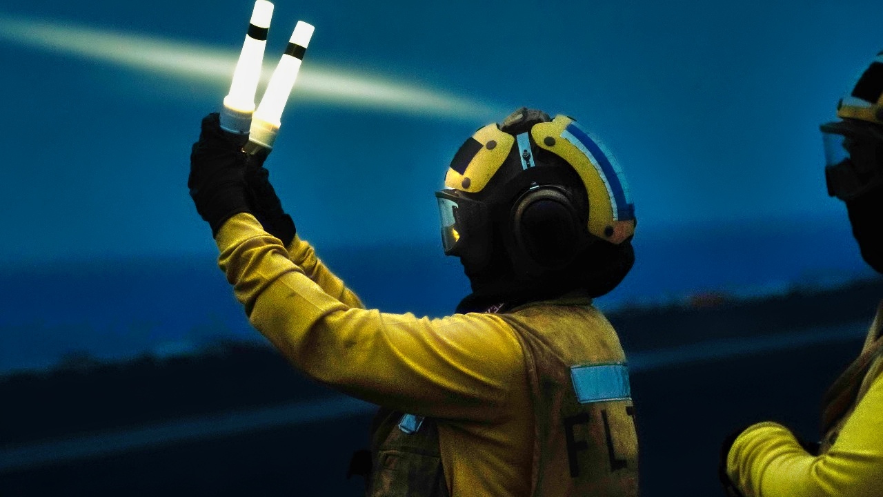U.S. 5TH FLEET AREA OF OPERATIONS (Aug. 6, 2024) An Aviation Boatswain’s Mate (Handling) signals aircraft on the flight deck of the Nimitz-class aircraft carrier USS Theodore Roosevelt (CVN 71), Aug. 6. Theodore Roosevelt is deployed to the U.S. 5th Fleet area of operations to support maritime security and stability in the U.S. Central Command area of responsibility. (Official U.S. Navy photo)