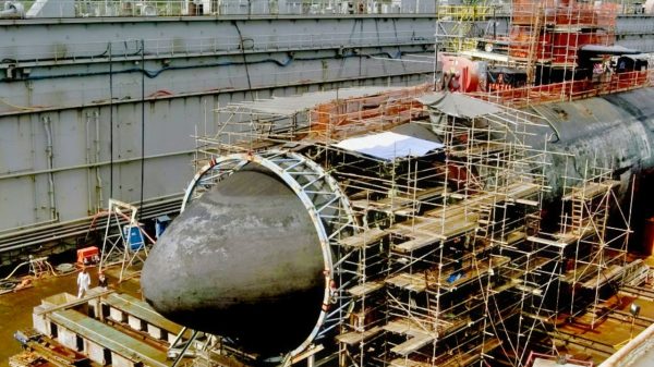 The Los Angeles class submarine USS San Francisco (SSN 711) shown in dry dock is having repairs made on its damaged bow. A new large steel dome about 20 feet high and 20 feet in diameter was put in the place of the damaged bow. San Francisco ran aground 350 miles south of Guam Jan. 8, killing one crew member and injuring 23. U.S. Navy photo (RELEASED)