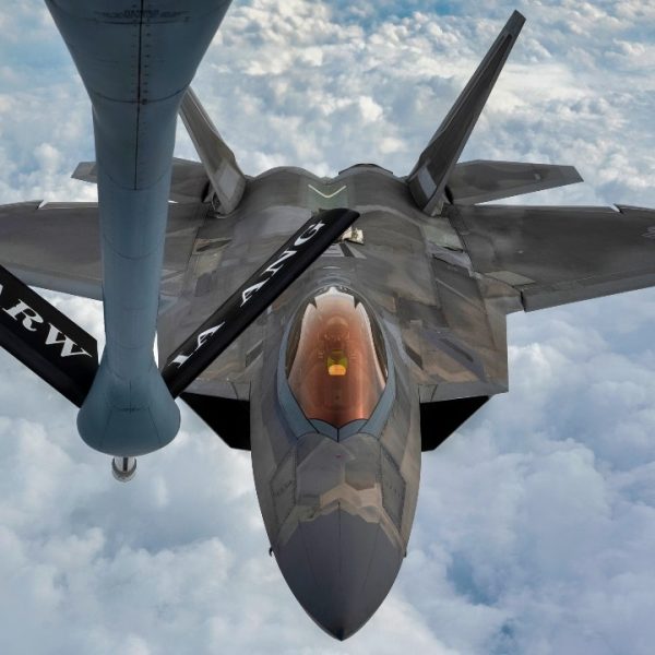 A U.S. Air Force F-22 Raptor approaches the boom of a KC-135 Stratotanker during a refueling mission over the Florida Panhandle, Dec. 14, 2022. Aerial refueling allows pilots to stay airborne for longer periods of time, increasing the mission capabilities individual aircraft can support. (U.S. Air Force photo by Tech. Sgt. Betty R. Chevalier)