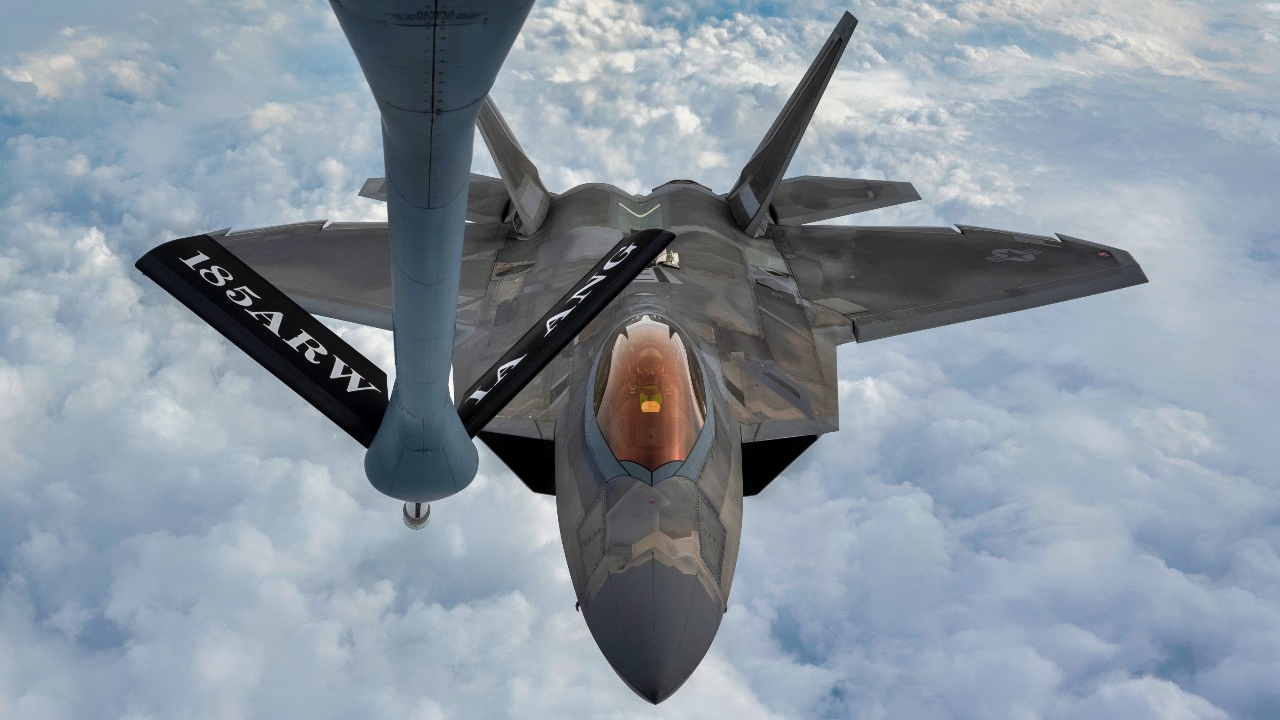 A U.S. Air Force F-22 Raptor approaches the boom of a KC-135 Stratotanker during a refueling mission over the Florida Panhandle, Dec. 14, 2022. Aerial refueling allows pilots to stay airborne for longer periods of time, increasing the mission capabilities individual aircraft can support. (U.S. Air Force photo by Tech. Sgt. Betty R. Chevalier)