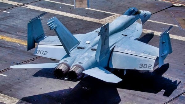 A Sailor directs an F/A-18E Super Hornet from the “Kestrels” of Strike Fighter Squadron (VFA) 137 on the flight deck of the aircraft carrier USS Nimitz (CVN 68) in the South China Sea, May 12, 2025. Nimitz is underway in the U.S. 7th Fleet area of operations on a scheduled deployment, demonstrating the U.S. Navy's unwavering commitment to a free and open Indo-Pacific. (U.S. Navy Photo by Mass Communication Specialist Seaman Apprentice Franklyn M. Guage)