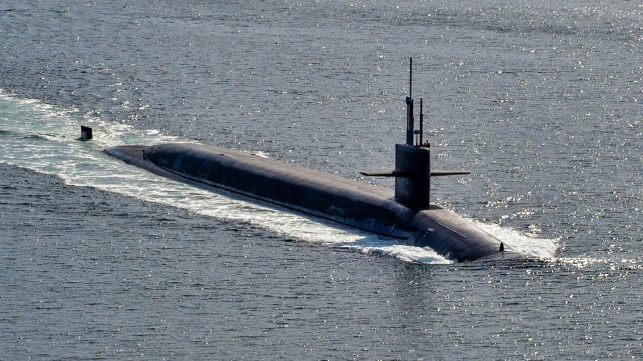 The Ohio-class ballistic-missile submarine USS Maine (SSBN 741) transits the Puget Sound during routine operations, March 18, 2025. Commander, Submarine Group (SUBGRU) 9, exercises administrative control authority for assigned submarine commands and units in the Pacific Northwest providing oversight for shipboard training, personnel, supply and material readiness of SSBNs and their crews. SUBGRU-9 is also responsible for nuclear submarines undergoing conversion or overhaul at Puget Sound Naval Shipyard in Bremerton. (U.S. Navy photo by Mass Communication Specialist 1st Class Ryan Riley)