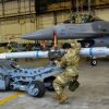 Airmen from the 35th Aircraft Maintenance Unit weapons load crew, transport an AIM 9 L/M Sidewinder with an MJ-1 bomb lift truck during the Annual Load Crew Competition at Kunsan Air Base, Republic of Korea, Feb. 6, 2021. Weapons load crews from the 35th Aircraft Maintenance Unit, 80th AMU and 8th Maintenance Squadron were evaluated on how quickly and effectively they could load munitions onto F-16 Fighting Falcons. (U.S. Air Force photo by Tech. Sgt. Kristin High)
