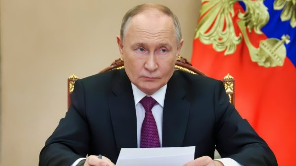 Russia's President Putin Sitting at a Desk