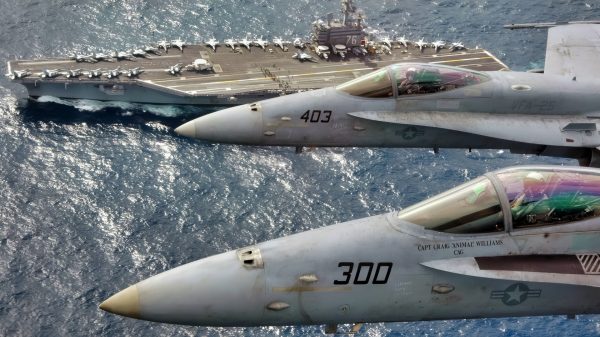 At sea (Mar. 1, 2007) – Capt. Craig “Animal” Williams (front) in a F/A 18C Hornet (front) and Capt. Richard “Rhett” Butler (back) in an F/A 18C Hornet look up for a photo as they fly over USS Ronald Reagan (CVN 76). Capt. Williams, a 22-year Naval Aviator who graduated from the United States Naval Academy, was relieved as Commander, Carrier Air Wing Fourteen (CVW-14) by 21-year Naval Aviator, Capt. Butler, a graduate of the University of Kentucky during an aerial change of command ceremony. The Ronald Reagan Carrier Strike Group is currently underway in the Pacific Ocean on a surge deployment in support of U.S. military operations in the Western Pacific. Official U.S. Navy photo by Lt. Cmdr. Tam Pham