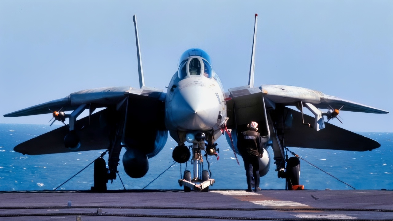 At sea aboard USS Abraham Lincoln (CVN 72)-- A lone plane captain conducts a walk around inspection of his F-14D Tomcat that is assigned to Fighter Squadron Three One (VF-31). THe F-14D is armed with AIM-9 Siderwinder Missiles and a Joint Direct Attack Munition (JDAM) and a GBU-14. USS Abraham Lincoln (CVN 72) and Carrier Air Wing FOURTEEN (CVW 14) are conducting combat operations in support of Operation Southern Watch. U.S. Navy photo by Photographer's Mate Third Class (AW/PJ) Philip A. McDaniel. Cleared for release by ALBG PAO, LCDR Jeff Bender.