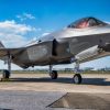 A U.S. Airman and two U.S. Marines support an F-35A Lightning II during joint hot pit refueling training at Kadena Air Base, Japan, March 10, 2022. Hot pit refueling uses a single-point refuel pump, which allows an aircraft to be rapidly refueled immediately after landing, while the engine is running. This cuts down on response time and ensures the mission can be completed anytime, anywhere. (U.S. Air Force photo by Airman 1st Class Anna Nolte)
