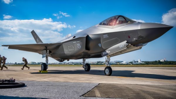 A U.S. Airman and two U.S. Marines support an F-35A Lightning II during joint hot pit refueling training at Kadena Air Base, Japan, March 10, 2022. Hot pit refueling uses a single-point refuel pump, which allows an aircraft to be rapidly refueled immediately after landing, while the engine is running. This cuts down on response time and ensures the mission can be completed anytime, anywhere. (U.S. Air Force photo by Airman 1st Class Anna Nolte)