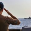 U.S. CENTRAL COMMAND AREA OF RESPONSIBILITY (Aug. 25, 2025) The executive officer of the Arleigh Burke-class guided-missile destroyer USS Truxtun (DDG 103) renders honors to the USS Forrest Sherman (DDG-98) aboard the USS Truxtun, in the U.S. Central Command area of responsibility. (Official U.S. Navy photo)