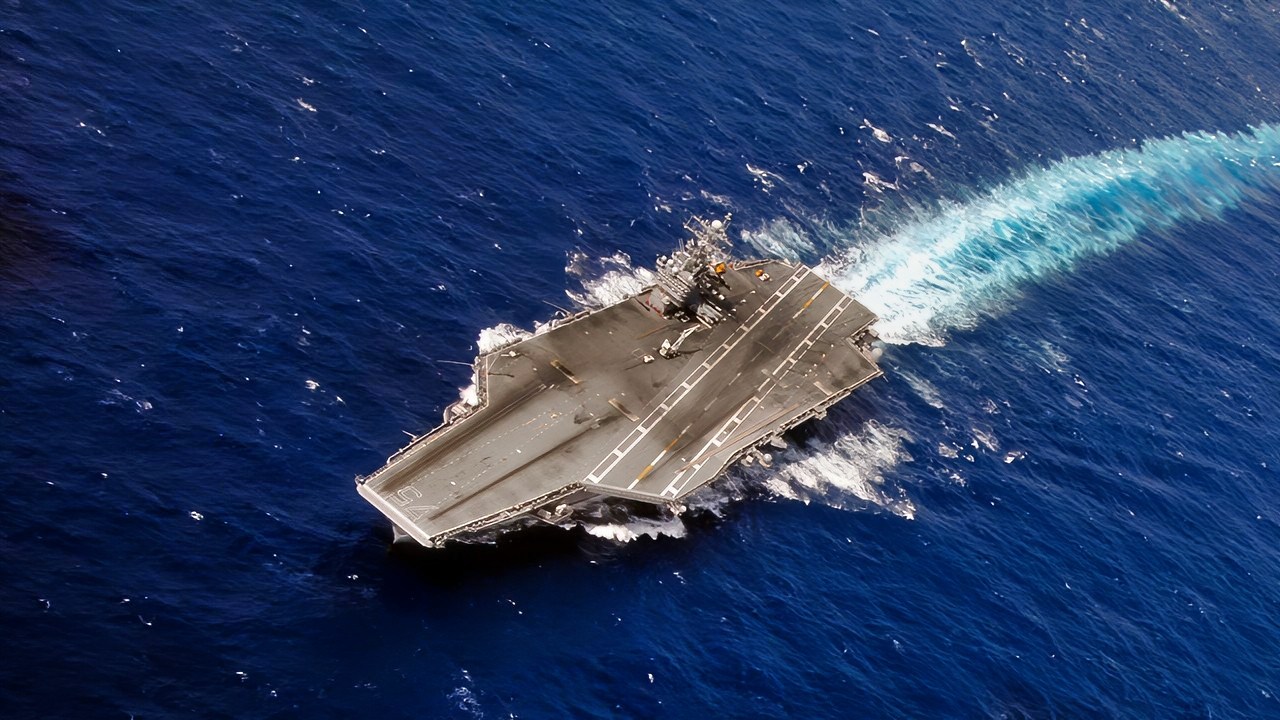 The aircraft carrier USS Harry S. Truman conducts high-speed turns during a rudder check. Truman is conducting carrier qualifications in the Atlantic Ocean.