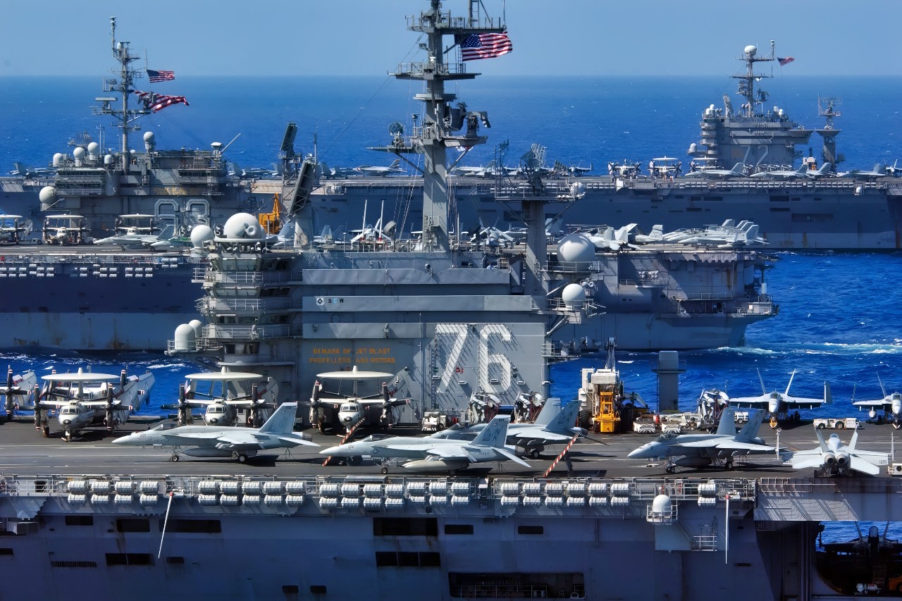 USS Ronald Reagan (CVN 76), USS Kitty Hawk (CV 63), and USS Abraham Lincoln (CVN 72) cruise side-by-side in the Philippine Sea June 18, 2006, during exercise Valiant Shield 2006. The joint exercise consists of 28 naval vessels, more than 300 aircraft, and approximately 20,000 service members from the Navy, Army, Air Force, Marine Corps and Coast Guard. (U.S. Navy photo by Chief Photographer's Mate Spike Call) (Released)