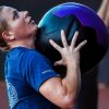 A U.S. Soldier, assigned to Headquarters and Headquarters Battalion, XVIII Airborne Corps, prepares to throw a weighted medicine ball during a physical training session at Segra Stadium in Fayetteville, N.C., July 15, 2025. The full-body exercise was part of a circuit training rotation designed to boost strength and endurance. (U.S. Army photo by Sgt. Gianna Elle Sulger)