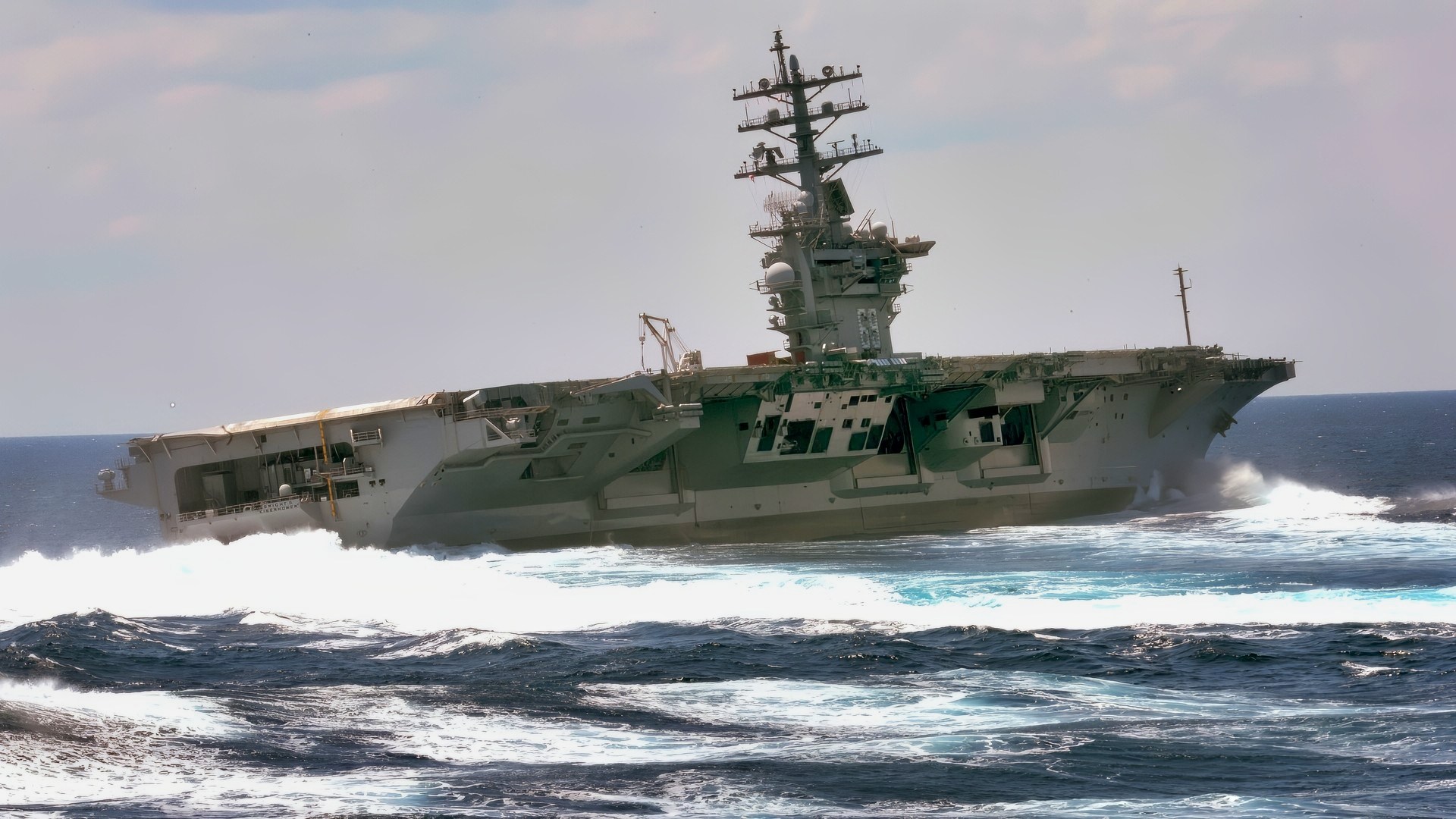 The Nimitz-class aircraft carrier USS Dwight D. Eisenhower conducts rudder turns during sea trials.