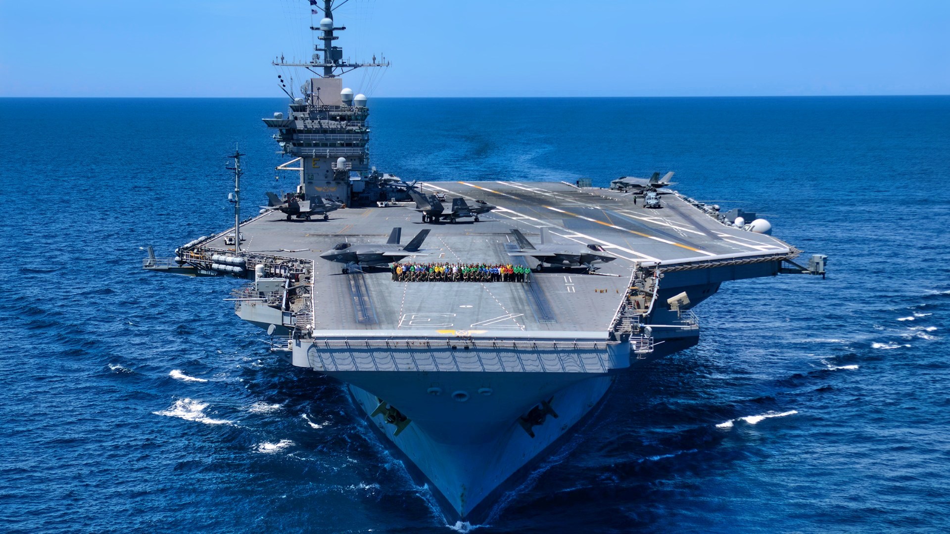 ATLANTIC OCEAN (Aug. 16, 2016) Sailors assigned to the Grim Reapers of Strike Fighter Squadron (VFA) 101, the Navy’s F-35C Fleet replacement squadron, pose on the flight deck of the aircraft carrier USS George Washington (CVN 73) during an aerial photo exercise. VFA-101 aircraft and pilots are conducting initial qualifications aboard George Washington in the Atlantic Ocean. The F-35C is expected to be Fleet operational in 2018. (U.S. Navy photo by Mass Communication Specialist Seaman Apprentice Krystofer Belknap)