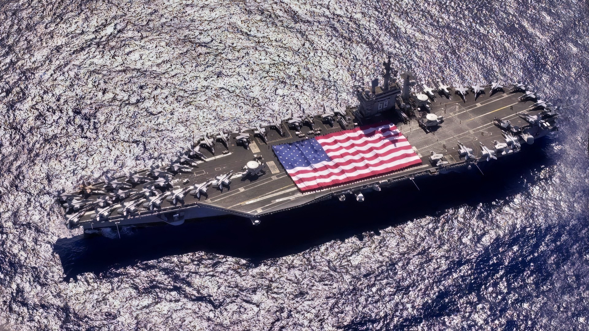 Pacific Ocean (November 3, 2003) -- During Tiger Cruise aboard USS Nimitz (CVN 68), Nimitz and Carrier Air Wing Eleven personnel participate in a flag unfurling rehearsal with the help of fellow tigers on the flight deck. The Nimitz Carrier Strike Force and Carrier Air Wing Eleven (CVW-11) are in route to Nimitz homeport of San Diego, California after an eight-month deployment to the Arabian Gulf in support of Operation Iraqi Freedom. U.S. Navy photo.
