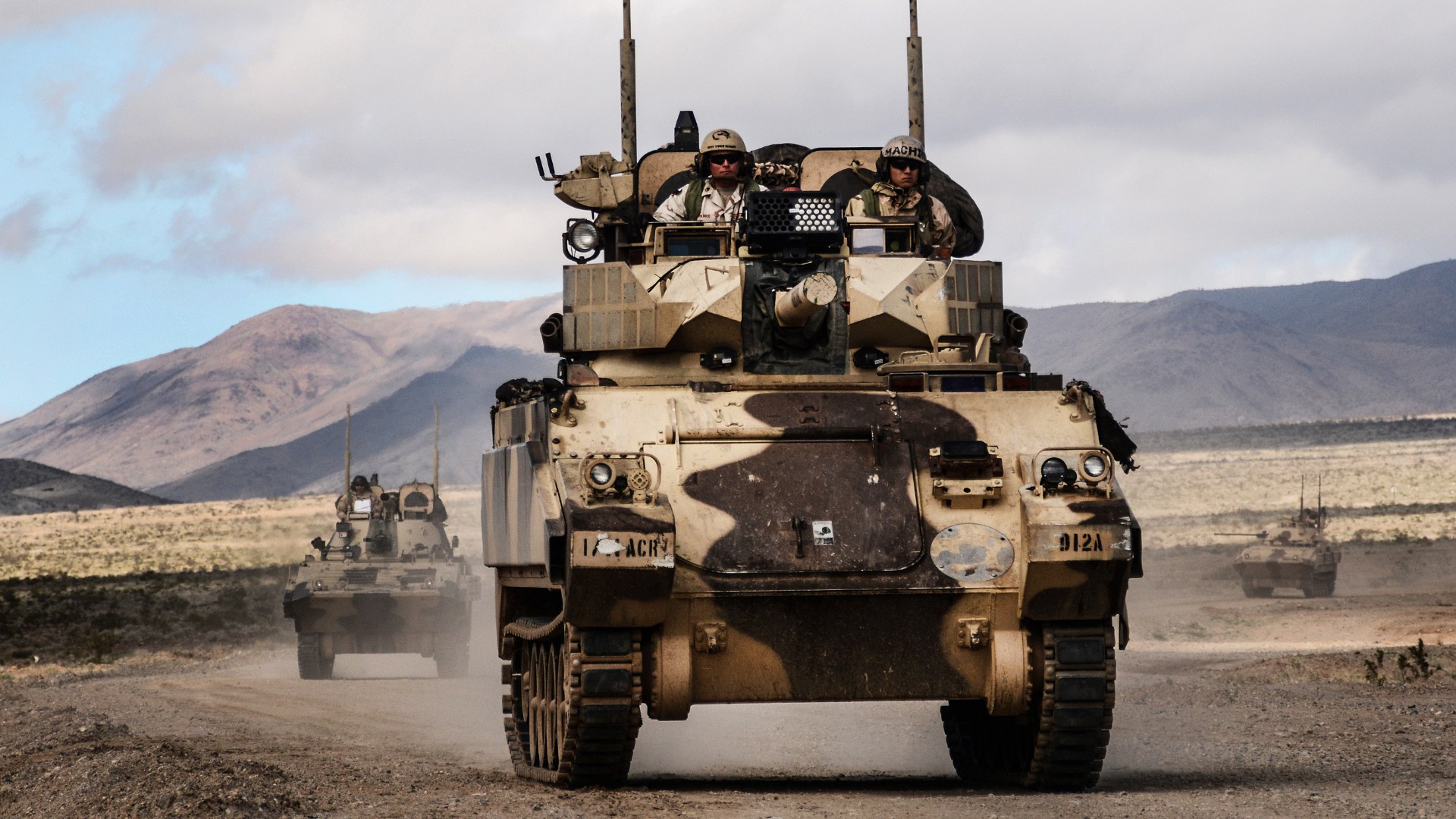 FORT IRWIN, Calif. – A Main Battle Tank and Infantry Fighting Vehicles of Dealer Troop, 1st Squadron, 11th Armored Cavalry Regiment approach the town of Barasu in the National Training Center to stage a counterattack against the 2nd Armored Brigade Combat Team, 1st Cavalry Division, Feb. 20, 2017. The counterattack by the 11th ACR challenged the 2/1 ABCT to combat a well-equipped and formidable opponent while defending an urban objective. (U.S. Army photo by Pvt. Austin Anyzeski, 11th ACR)