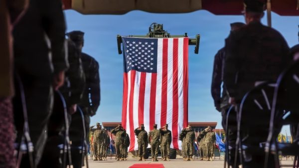 U.S. Marines and Sailors with 1st Dental Battalion, 1st Marine Logistics Group, salute the U.S. flag during a change of charge ceremony on Marine Corps Base Camp Pendleton, California, Nov. 7, 2025. The ceremony marked the formal transfer of responsibilities between senior enlisted leaders, symbolizing the continuity of leadership within the unit and the trust vested in those assuming greater duties. (U.S. Marine Corps photo by Lance Cpl. Alan Gomez)