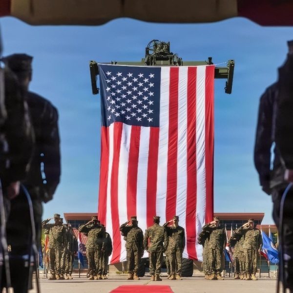 U.S. Marines and Sailors with 1st Dental Battalion, 1st Marine Logistics Group, salute the U.S. flag during a change of charge ceremony on Marine Corps Base Camp Pendleton, California, Nov. 7, 2025. The ceremony marked the formal transfer of responsibilities between senior enlisted leaders, symbolizing the continuity of leadership within the unit and the trust vested in those assuming greater duties. (U.S. Marine Corps photo by Lance Cpl. Alan Gomez)