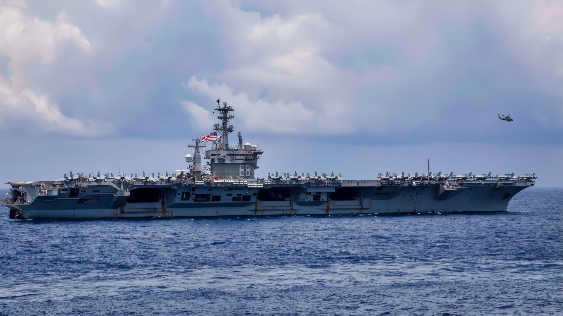 (Feb. 15, 2023) U.S. Navy aircraft carrier USS Nimitz (CVN 68) flies the battle ensign during expeditionary strike force operations with the Nimitz Carrier Strike Group including the Arleigh Burke-class guided-missile destroyer USS Decatur (DDG 73). Nimitz Carrier Strike Group (NIMCSG) and Makin Island Amphibious Ready Group (MKI ARG) with embarked 13th Marine Expeditionary Unit (MEU) are conducting combined ESF operations, demonstrating unique high-end war fighting capability, maritime superiority, power projection and readiness. Operations include integrated training designed to advance interoperability between the two groups while simultaneously demonstrating the U.S. commitment to our alliances and partnerships in the Indo-Pacific region. (U.S. Navy photo by Mass Communication Specialist 2nd Class David Negron)
