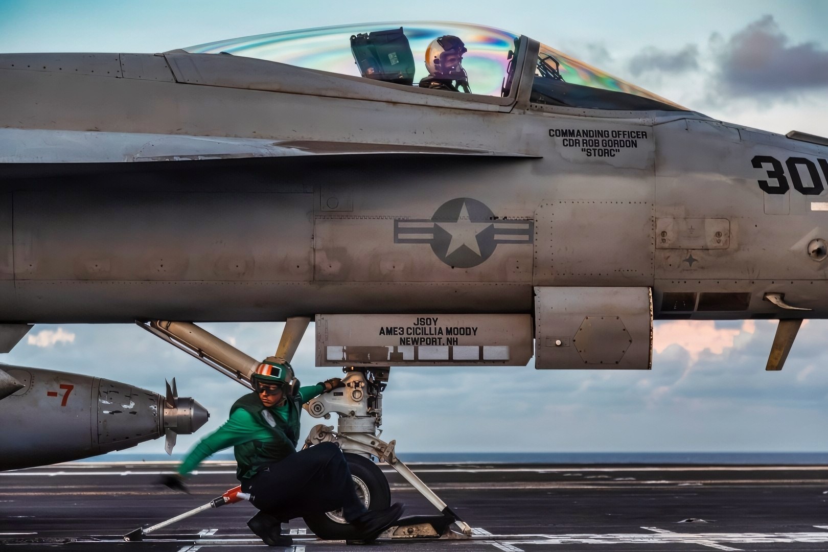 A U.S. Sailor prepares an F/A-18F Super Hornet aircraft for launch from the flight deck of the world's largest aircraft carrier, Ford-class aircraft carrier USS Gerald R. Ford (CVN 78), while underway in the Caribbean Sea, Nov. 25, 2025. U.S. military forces are deployed to the Caribbean in support of the U.S. Southern Command mission, Department of War-directed operations, and the president’s priorities to disrupt illicit drug trafficking and protect the homeland. (U.S. Navy photo)