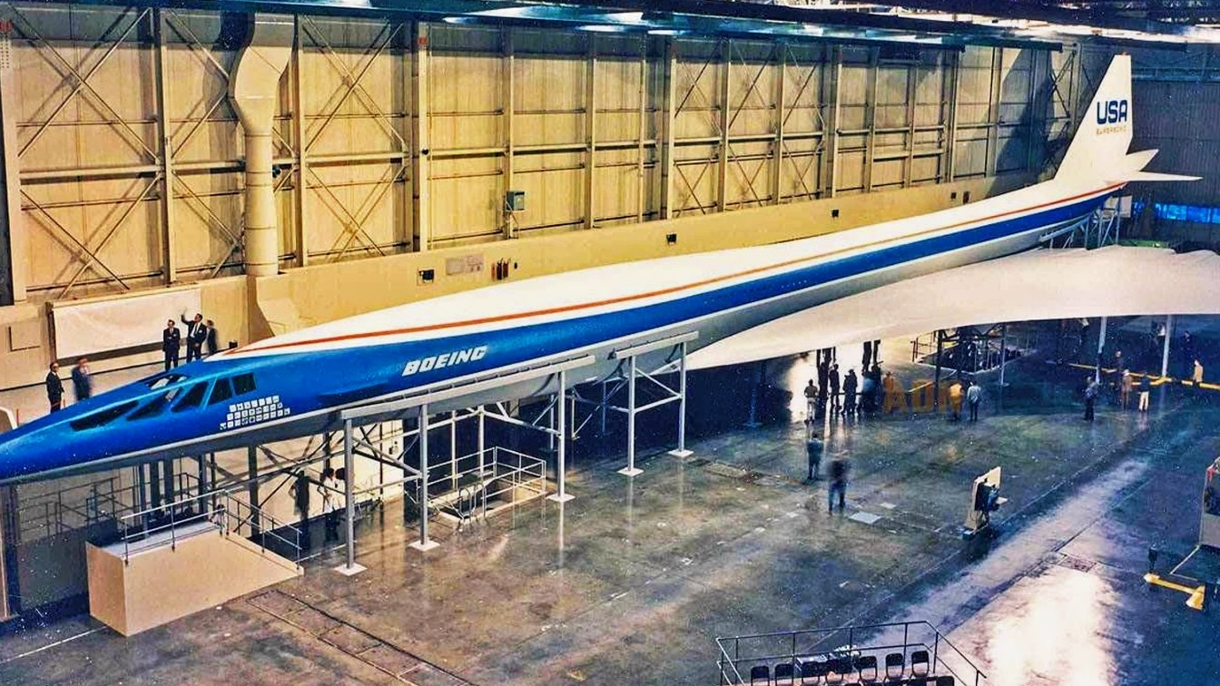 Boeing's 2707 supersonic transport was designed to fly at Mach 2.7 — 2,071 miles per hour — carrying up to 277 passengers, more than triple the capacity of the Anglo-French Concorde. Powered by four General Electric GE4 turbojets, the largest straight turbojet engines ever built, two prototypes were under construction in Seattle when Congress killed the program in 1971 by a single Senate vote. Boeing laid off more than 60,000 workers, pivoted to the subsonic 747, and 55 years later no American supersonic airliner has ever entered service.