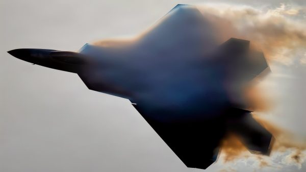 A U.S. Air Force F-22 Raptor emerges from a cloud of vapor during an aerial demonstration at Naval Air Station Meridian, Mississippi, March 27, 2026. The F-22 is designed to perform high-performance maneuvers that showcase its maneuverability and control in flight. The visible vapor forms when rapid changes in air pressure and humidity around the aircraft cause water vapor in the air to condense. (U.S. Air Force photo by Staff Sgt. Lauren Diaz)