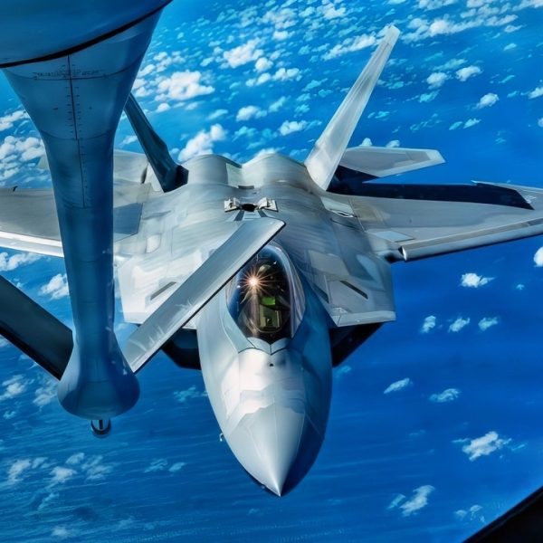A U.S. Air Force F-22 Raptor assigned to the 27th Expeditionary Fighter Squadron, deployed to Kadena Air Base, Japan, approaches a KC-135 Stratotanker assigned to the 909th Air Refueling Squadron during a training flight over the Pacific Ocean, July 8, 2026. Aerial refueling capabilities extend airborne training time and combat radius, ensuring joint and allied aircraft are postured to maintain regional peace and stability within the Indo-Pacific. (U.S. Air Force photo by Staff Sgt. Erin Currie) 18 WG/PA