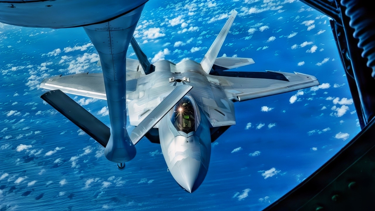 A U.S. Air Force F-22 Raptor assigned to the 27th Expeditionary Fighter Squadron, deployed to Kadena Air Base, Japan, approaches a KC-135 Stratotanker assigned to the 909th Air Refueling Squadron during a training flight over the Pacific Ocean, July 8, 2026. Aerial refueling capabilities extend airborne training time and combat radius, ensuring joint and allied aircraft are postured to maintain regional peace and stability within the Indo-Pacific. (U.S. Air Force photo by Staff Sgt. Erin Currie) 18 WG/PA