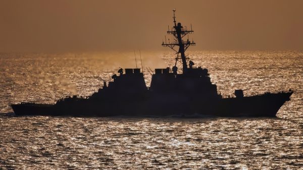 The guided-missile destroyer USS Donald Cook (DDG 75) steams behind the aircraft carrier USS Theodore Roosevelt (CVN 71) in the Persian Gulf on Jan. 31, 2006. The Roosevelt Carrier Strike Group is conducting maritime security operations in the Persian Gulf.