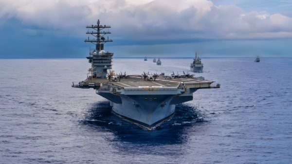 Twenty-six ships from 13 partner and allied nations steam in formation with Nimitz-class aircraft carrier USS Nimitz (CVN 68) during a multinational maritime exercise as part of Fleet Exercise (FLEETEX) 250 in the Atlantic Ocean, June 25, 2026. Nimitz is underway taking part in FLEETEX 250, a series of structured multilateral training events at-sea, aimed at building cohesiveness, validating tactical procedures, and strengthening the interoperability of participating units—which include warships, aircraft, and crews from the U.S. and 13 partner and ally nations. (U.S. Navy photo by Mass Communication Specialist Seaman Julian Jaime)