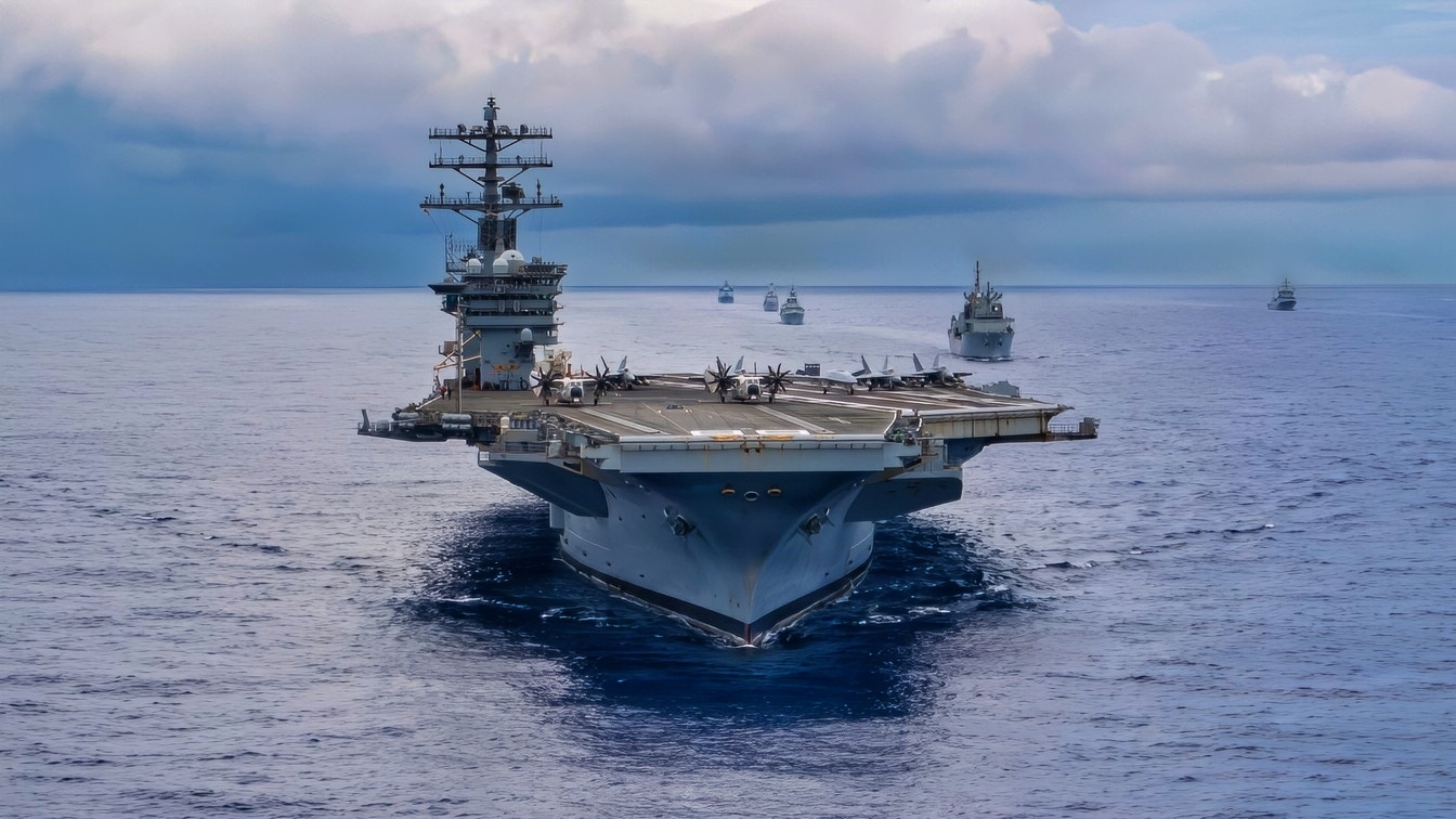 Twenty-six ships from 13 partner and allied nations steam in formation with Nimitz-class aircraft carrier USS Nimitz (CVN 68) during a multinational maritime exercise as part of Fleet Exercise (FLEETEX) 250 in the Atlantic Ocean, June 25, 2026. Nimitz is underway taking part in FLEETEX 250, a series of structured multilateral training events at-sea, aimed at building cohesiveness, validating tactical procedures, and strengthening the interoperability of participating units—which include warships, aircraft, and crews from the U.S. and 13 partner and ally nations. (U.S. Navy photo by Mass Communication Specialist Seaman Julian Jaime)